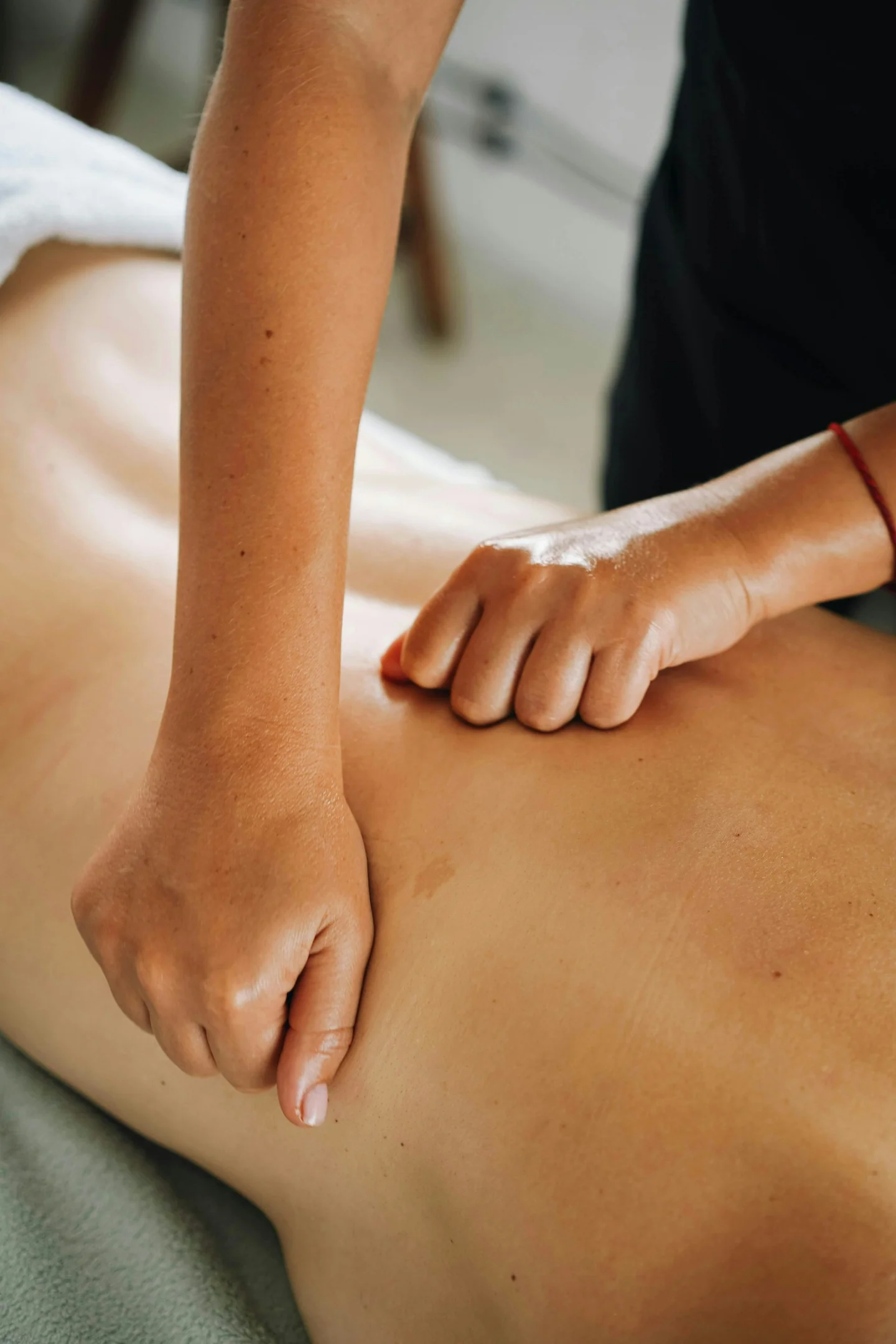 Massage therapist giving a back massage